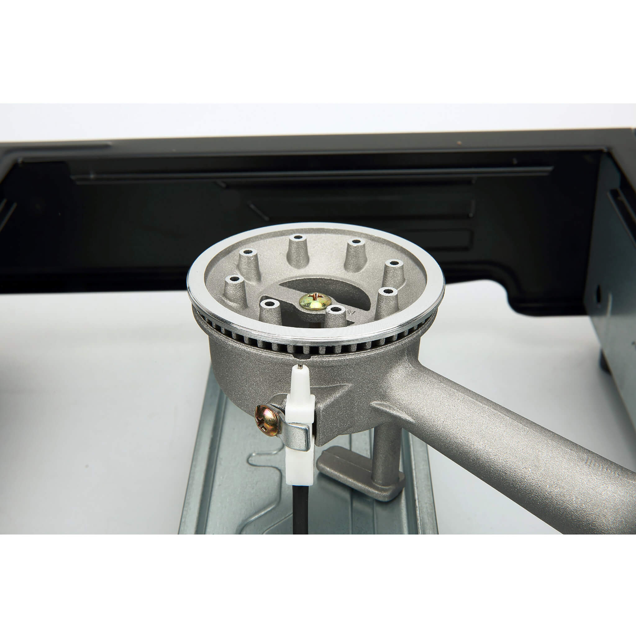 Close-up of a gas stove burner and automatic piezo ignition