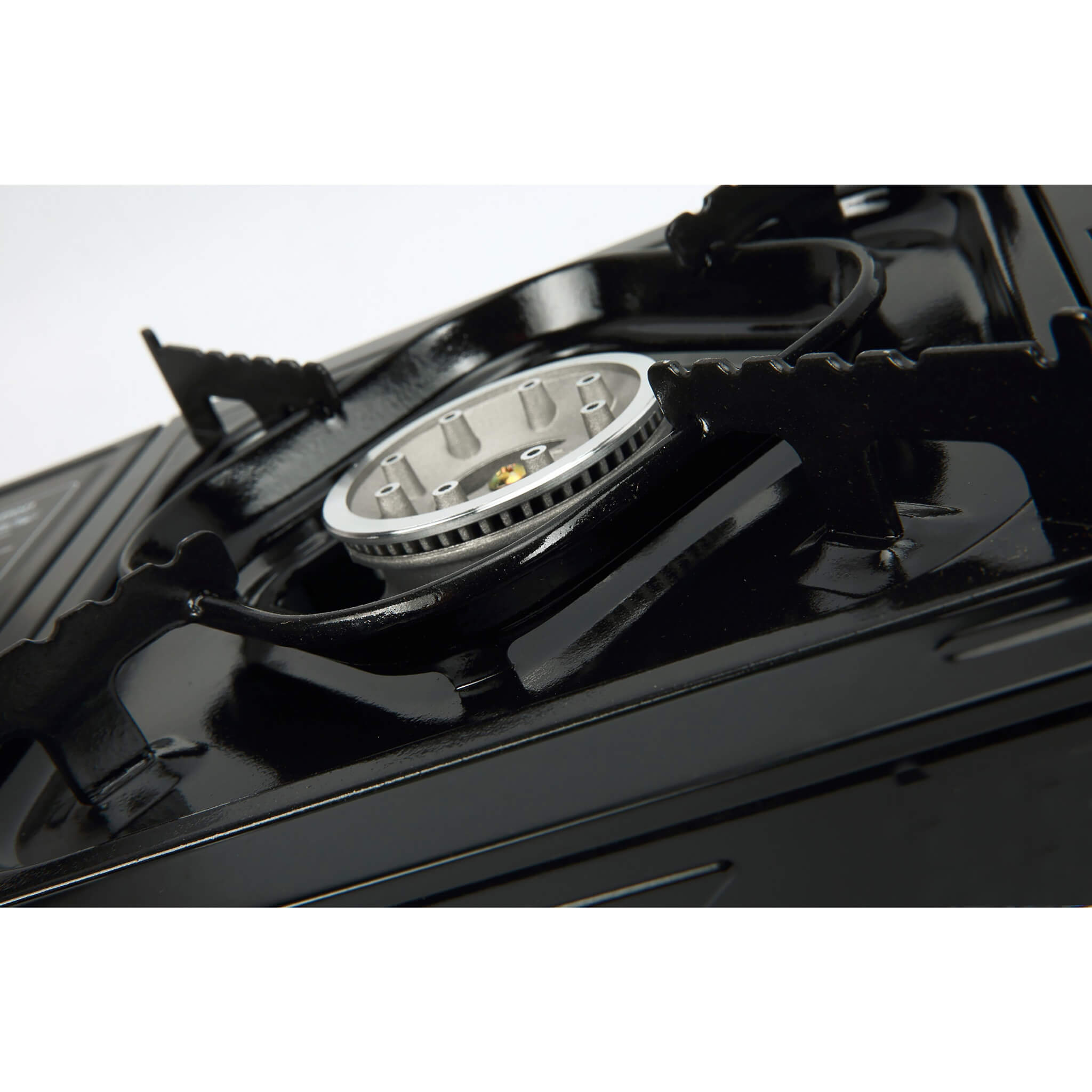 Close-up of a black stove burner with removable pan supports