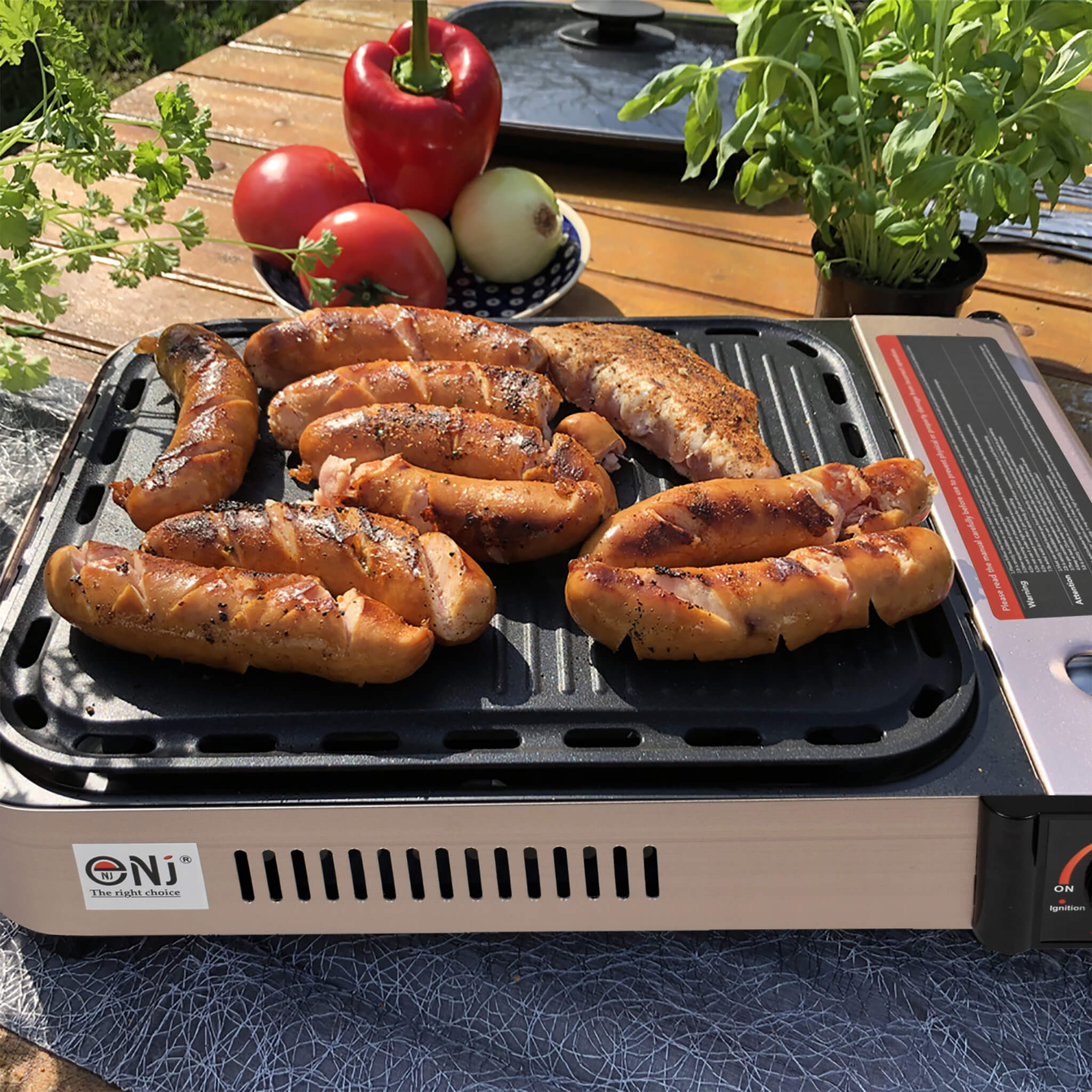 Grill with sausages and vegetables on a wooden table