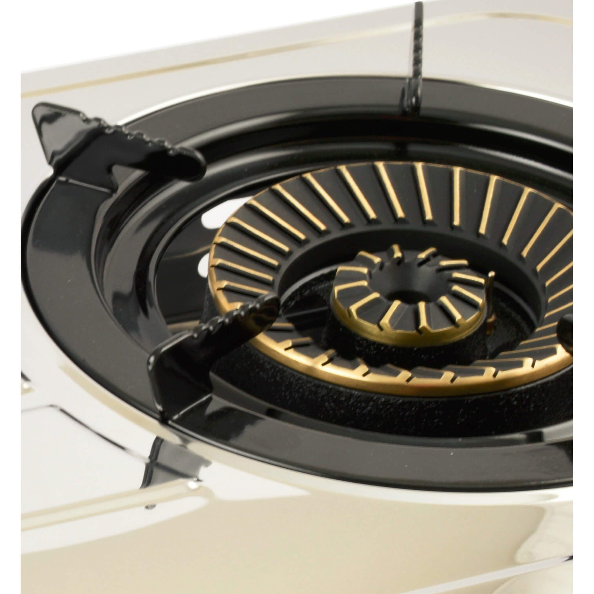 Close-up of a gas stove brass burner with enamel pan support