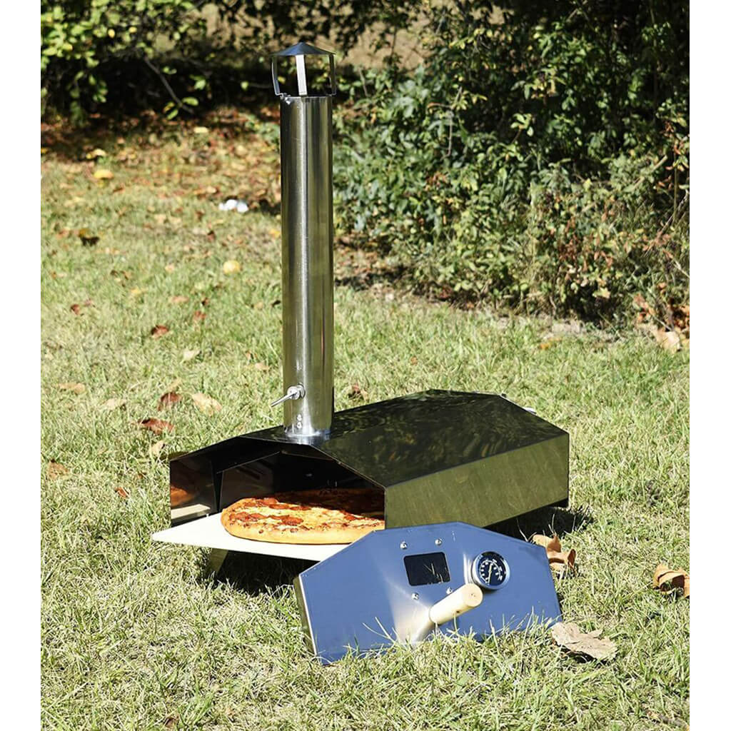 Portable outdoor pizza oven with a pizza on a grassy area