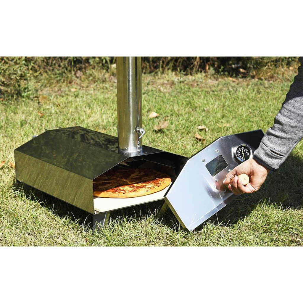 Portable pizza oven being used outdoors with a pizza inside