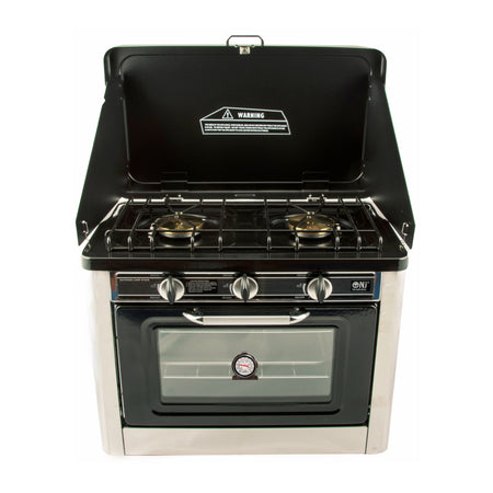 A portable stainless steel camping gas stove with two burners and an oven, displayed against a white background.